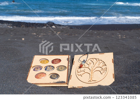 Healing crystals on black sand background Healing crystals on black sand background 123341085