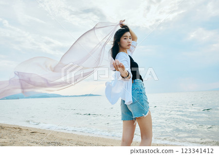 Woman looking at the summer sea Woman looking at the summer sea 123341412