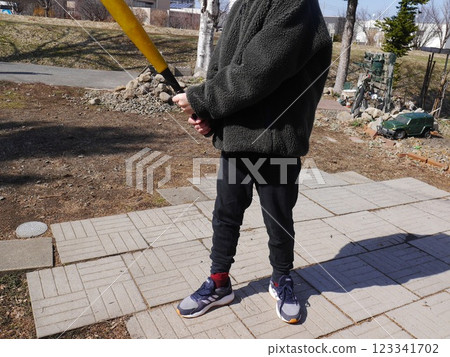 Child swinging a bat (no face) Child swinging a bat (no face) 123341702