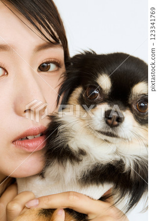 Woman holding her pet close to her cheek Woman holding her pet close to her cheek 123341769