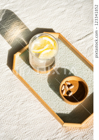 lemon water and nutritional supplement capsules for self care. lemon water and nutritional supplement capsules for self care. 123341852