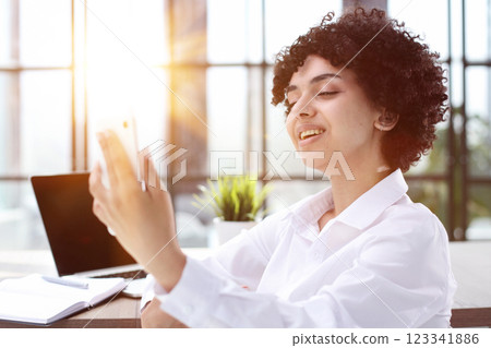 Portrait of Young Successful Caucasian Businesswoman Sitting at Desk Working on Laptop Portrait of Young Successful Caucasian Businesswoman Sitting at Desk Working on Laptop 123341886