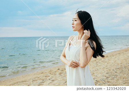 Woman looking at the summer sea 123342020