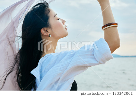 Woman looking at the summer sea Woman looking at the summer sea 123342061