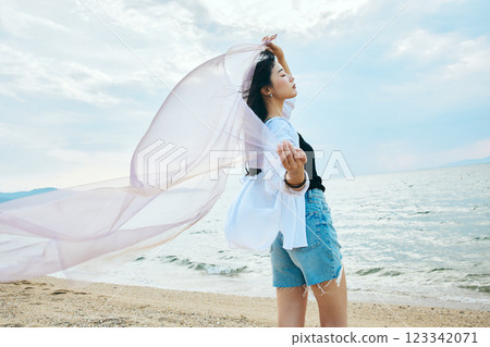 Woman looking at the summer sea Woman looking at the summer sea 123342071