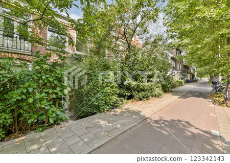 A vibrant pathway surrounded by lush greenery and trees, leading through an urban environment, showcasing the harmony of nature and city life. 123342143
