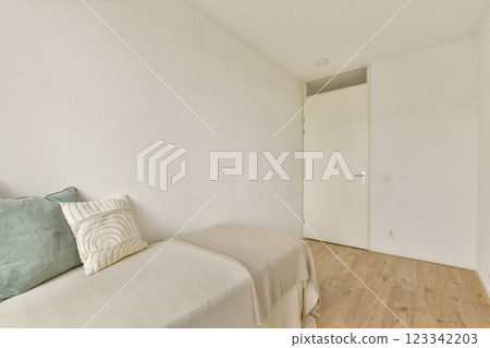 A clean, minimalist room featuring simple decor and neutral tones, emphasizing a sense of space and calm. The light-colored walls complement the light wooden floor. A clean, minimalist room featuring simple decor and neutral tones, emphasizing a sense of space and calm. The light-colored walls complement the light wooden floor. 123342203
