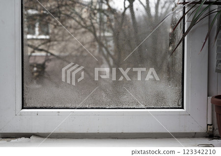 plastic window is fogged up. drops of water gathered on the glass plastic window is fogged up. drops of water gathered on the glass 123342210