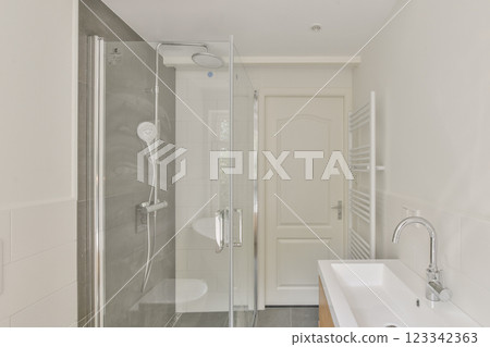 A contemporary bathroom featuring a glass shower enclosure, sleek fixtures, and minimalist design elements, perfect for a relaxing atmosphere. A contemporary bathroom featuring a glass shower enclosure, sleek fixtures, and minimalist design elements, perfect for a relaxing atmosphere. 123342363