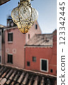 Antique lamp swaying on an Italian balcony 123342445