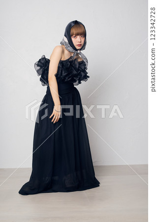 A woman in a black dress 123342728