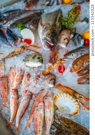 Different fresh sea food for a choice on ice in market or restaurant in small town of Montenegro. Seafood of adriatic sea Different fresh sea food for a choice on ice in market or restaurant in small town of Montenegro. Seafood of adriatic sea 123342826