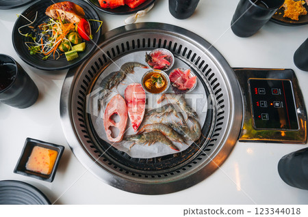Shrimp and fish are grilled on stove in buffet in an Asian restaurant in Asia in Vietnam. Fresh seafood is fried Shrimp and fish are grilled on stove in buffet in an Asian restaurant in Asia in Vietnam. Fresh seafood is fried 123344018