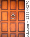 Classic Venetian wooden door with metal knocker 123344270