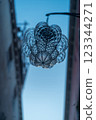 A glass lamp shining on a street corner in Venice 123344271
