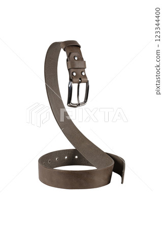 A brown leather belt with a metal buckle is beautifully curved and isolated on a white background. 123344400