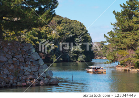 A sightseeing boat sailing through the moat of Matsue Castle (Matsue City) A sightseeing boat sailing through the moat of Matsue Castle (Matsue City) 123344449
