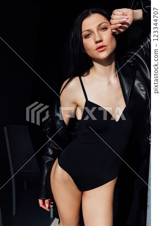 Beautiful slim fashion brunette woman in leather jacket 123344707