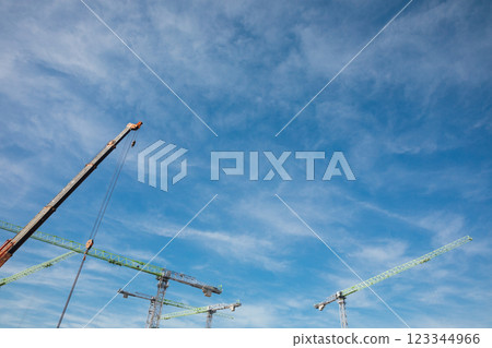 Construction cranes for building houses against blue sky background 123344966