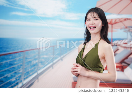 Young woman in swimsuit enjoying a cruise trip 123345246