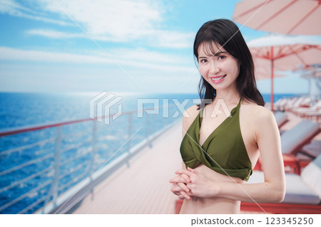 Young woman in swimsuit enjoying a cruise trip Young woman in swimsuit enjoying a cruise trip 123345250