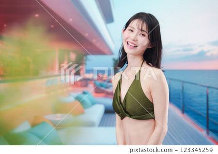 Young woman in swimsuit enjoying a cruise trip 123345259