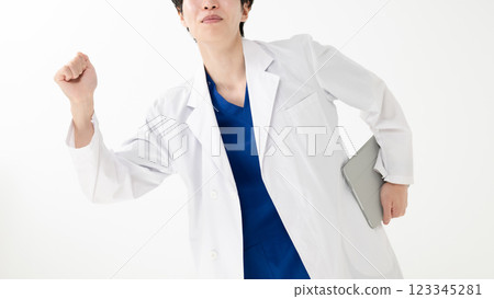 A young male doctor pumping his fist A young male doctor pumping his fist 123345281