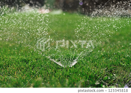 Automatic lawn watering watering green grass. Automatic lawn watering watering green grass. 123345818