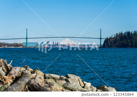 Lions Gate Bridge with snowcapped mountain Mount Baker in the background. Beautiful landscape view from West Vancouver Centennial Seawalk, BC, Canada. Lions Gate Bridge with snowcapped mountain Mount Baker in the background. Beautiful landscape view from West Vancouver Centennial Seawalk, BC, Canada. 123345864