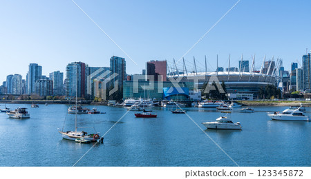 Vancouver, BC, Canada - April 16 2021 : Vancouver marina, False Creek, modern buildings skyline in the background. BC Place. 123345872