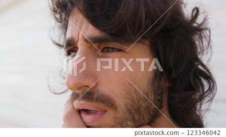 Long Haired Man Stares Into Void Immersed in His Thoughts and Thinking Long Haired Man Stares Into Void Immersed in His Thoughts and Thinking 123346042