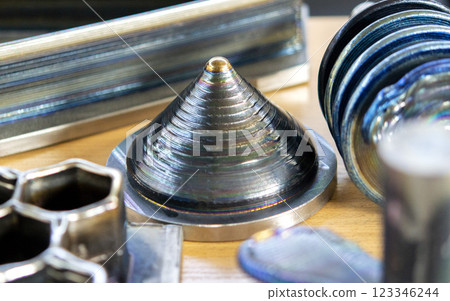 Objects printed with a 3D printer from a filament of molten metal on a table. Objects printed with a 3D printer from a filament of molten metal on a table. 123346244