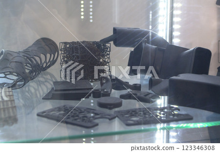 Complex multi-part models printed on 3D printer from black polyamide powder. Detailed prototype created on 3D printer from plastic powder. 3D printing powder technology Multi Jet Fusion MJF technology 123346308