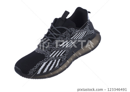 Black sneakers with white fabric stripes close-up on a white background. 123346491