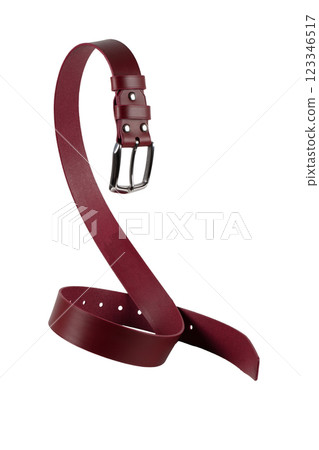 A brown leather belt with a metal buckle is beautifully curved and isolated on a white background. 123346517
