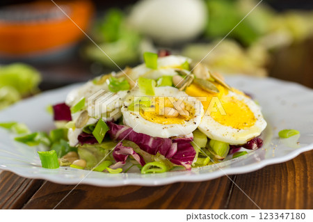 Appetizing egg dish in a plate on a wooden table 123347180