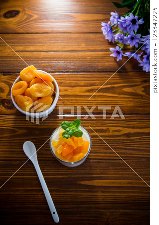 Light breakfast with fruit yogurt and dried apricots Light breakfast with fruit yogurt and dried apricots 123347225