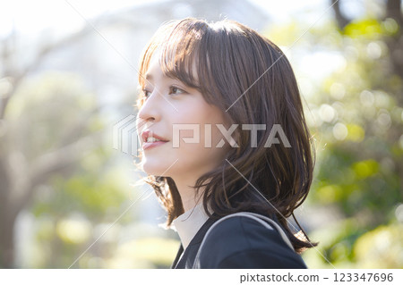 Young business woman walking in a suit Young business woman walking in a suit 123347696