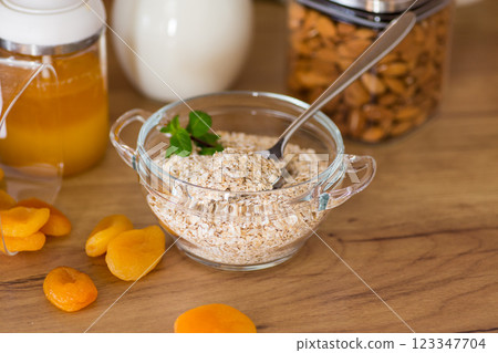 bowl of oatmeal with dried fruits and nuts for breakfast bowl of oatmeal with dried fruits and nuts for breakfast 123347704
