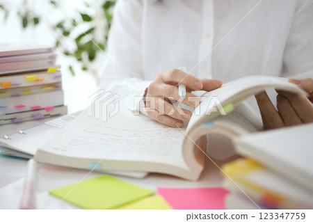 The hands of a middle-aged woman studying The hands of a middle-aged woman studying 123347759