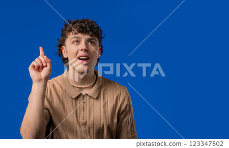 Brainy man having idea eureka moment, pointing finger up. Solution. Copy space Brainy man having idea eureka moment, pointing finger up. Solution. Copy space 123347802