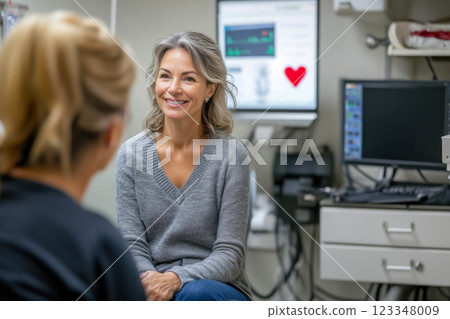 Middle aged woman in doctor's office during consultation with specialist after undergoing screening, patient talking with doctor, concept of timely annual health checkup Middle aged woman in doctor's office during consultation with specialist after undergoing screening, patient talking with doctor, concept of timely annual health checkup 123348009