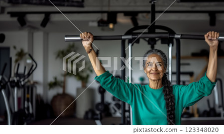 Portrait with smiling senior woman doing strength training on exercise machines in gym, copy space for health and exercise concept for seniors Portrait with smiling senior woman doing strength training on exercise machines in gym, copy space for health and exercise concept for seniors 123348020