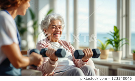 Older woman in a rehabilitation session with a doctor-trainer lifts dumbbells, poster highlighting therapy, care activities that improve the overall health of older adults 123348046