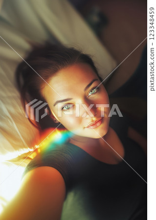Vertical portrait of young woman with sun glare on face taking selfie, beautiful model looking at camera and seaside resort vacation concept Vertical portrait of young woman with sun glare on face taking selfie, beautiful model looking at camera and seaside resort vacation concept 123348459