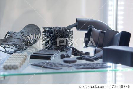Various object printed on a 3D printer from molten plastic powder. Different model printed on 3D printer from melted black polyamide powder. New additive 3D printing Multi Jet Fusion MJF technology Various object printed on a 3D printer from molten plastic powder. Different model printed on 3D printer from melted black polyamide powder. New additive 3D printing Multi Jet Fusion MJF technology 123348886