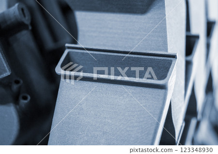 Complex multi-part model printed on 3D printer from black polyamide powder. Detailed prototype created on 3D printer from plastic close-up. 3D printing technology. Multi Jet Fusion MJF technology 123348930