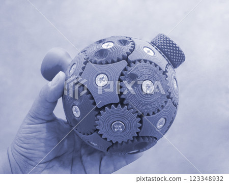 Person holding in hand three-dimensional model printed on 3D printer. An object created on 3D printer from molten plastic. 3D printing technology. Blue color. Additive modern progressive technologies 123348932