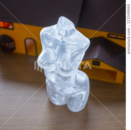 Small model of female body printed on 3D printer from molten transparent plastic. An object created on 3D printer from molten plastic. 3D printing technology. Additive modern progressive technologies 123349069