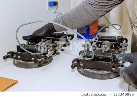 Worker prepares specialized tools for you can consistently produce virtually invisible seams with Stealth Seamer seamless countertop joints, levels, stone installation 123349980